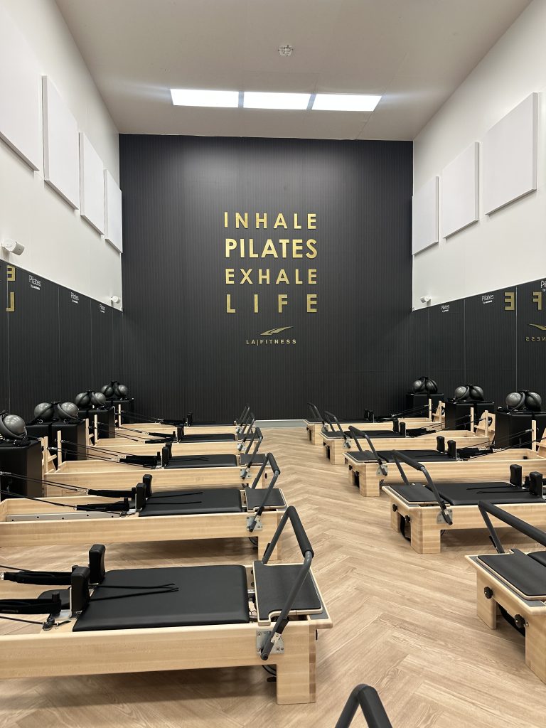 A row of new reformers at a standard gym available through Active&Fit Direct, showing how you can save money on gym memberships with big benefits without the obligation.